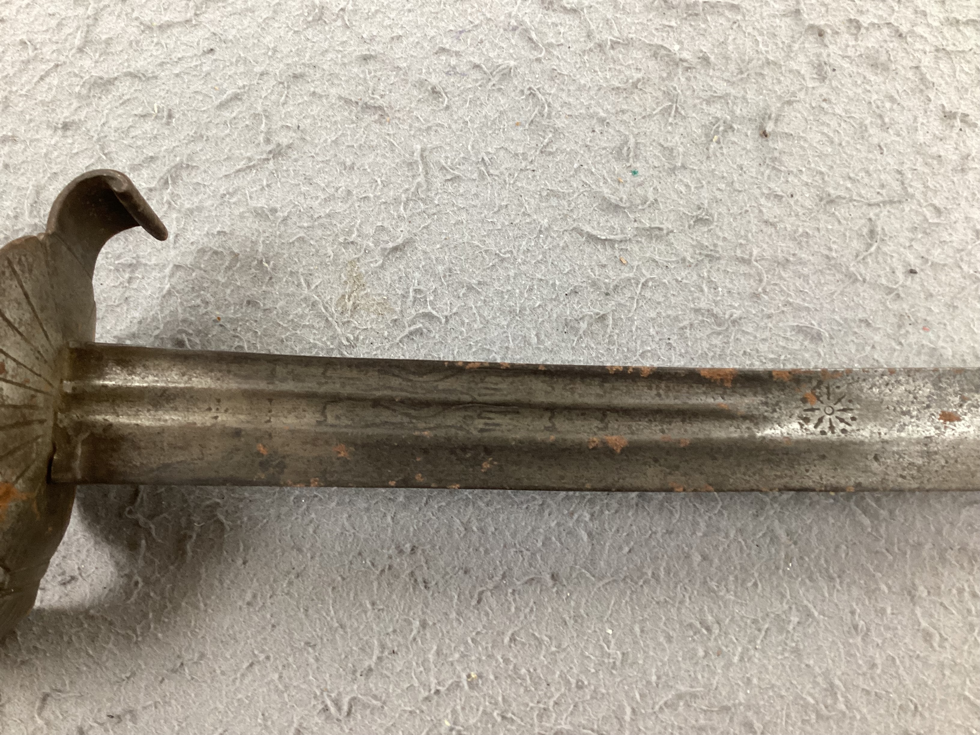 An English hangar, mid 17th century, curved fullered blade engraved with spurious date 1535 and running wolf mark, iron guard slightly reduced and swollen pommel, spirally carved and chequered bone grip, blade 67.5cm